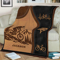 Close view of a custom bicycle blanket with mountain biker scenery, helmet graphics, and bicycle illustrations