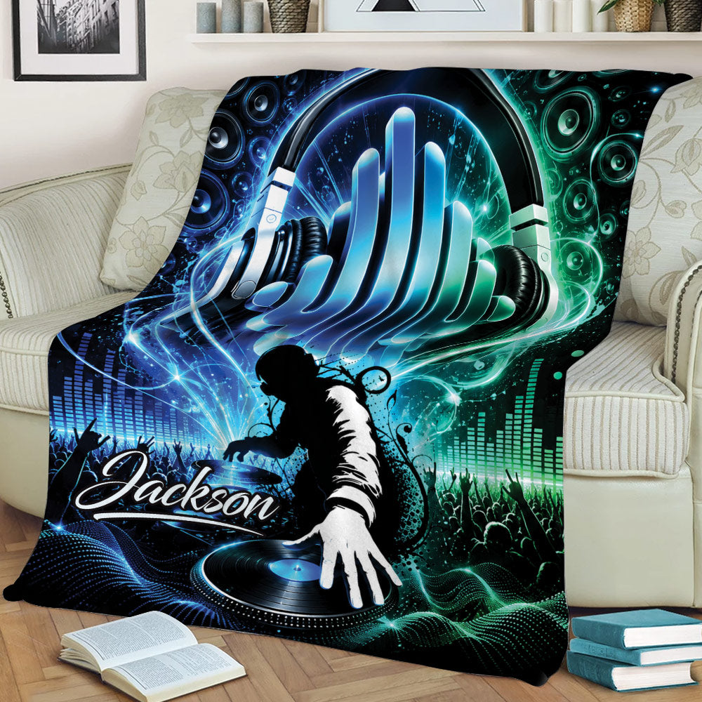 Colorful DJ blanket draped across a sofa with a headphone design, turntable, speakers, and crowd silhouette