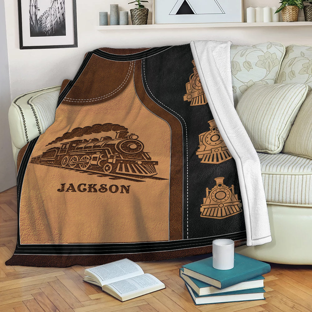 Railroad throw blanket displayed on a sofa with vintage steam train artwork
