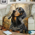Bluetick Coonhound blanket shown on a couch with realistic hound artwork and autumn woodland scenery