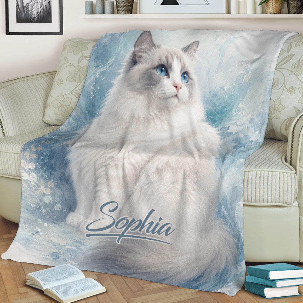 Ragdoll cat throw blanket displayed on a couch with a fluffy blue-eyed cat design