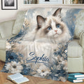 Ragdoll cat throw blanket displayed on a sofa with blue flowers and artistic portrait styling