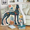Floral Great Dane blanket draped over a living room sofa with colorful botanical artwork