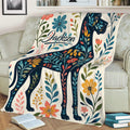 Great Dane throw blanket displayed on a sofa with vibrant floral and leafy artwork