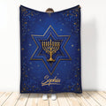 Blue and gold Hanukkah blanket with a menorah inside a Star of David and ornate floral border