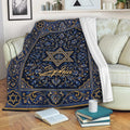 Hanukkah throw blanket with blue and gold floral artwork displayed on a living room sofa