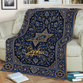 Decorative blue and gold Hanukkah blanket draped across a sofa with Star of David motifs