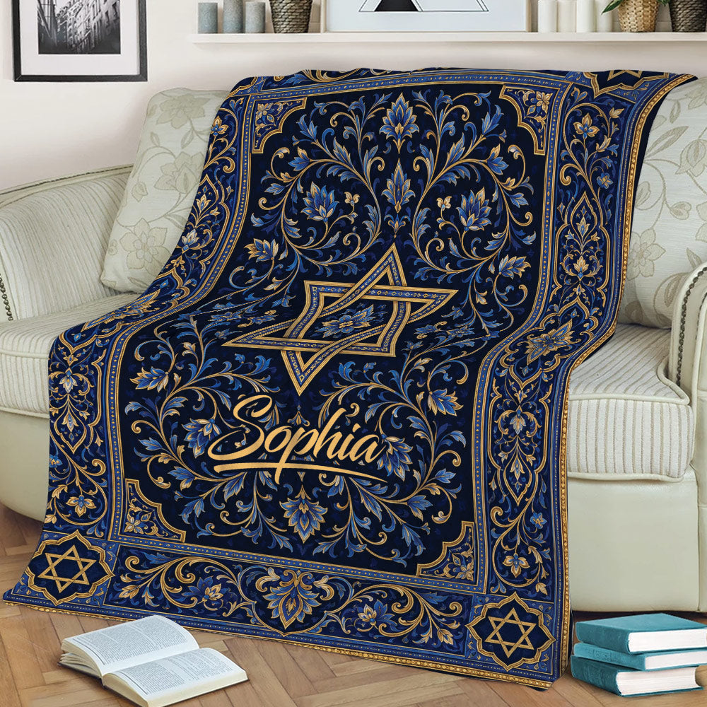 Decorative blue and gold Hanukkah blanket draped across a sofa with Star of David motifs