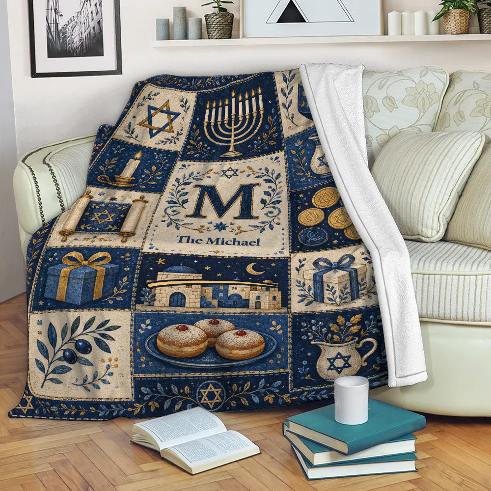 Hanukkah throw blanket styled on a sofa with menorah, dreidel, gift, and Jewish holiday motifs