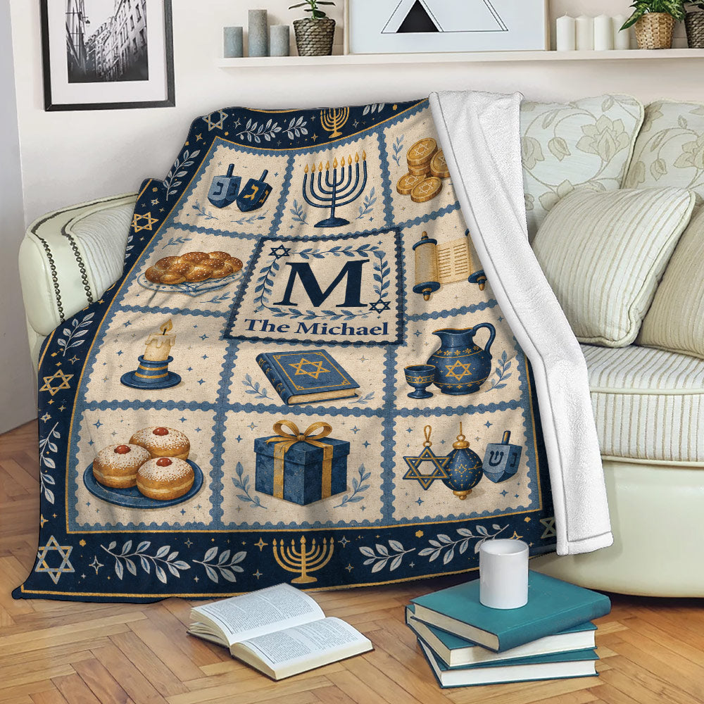 Hanukkah throw blanket displayed on a sofa with menorahs, dreidels, gelt, and festive Jewish symbols