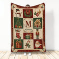 Christmas throw blanket with Santa, snowman, ornaments, tree, wreath, and traditional red and green holiday artwork