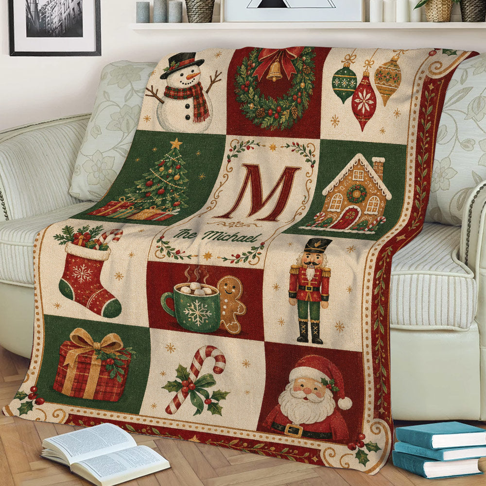 Close view of a Christmas blanket draped over a sofa with snowman, wreath, tree, gingerbread house, and Santa