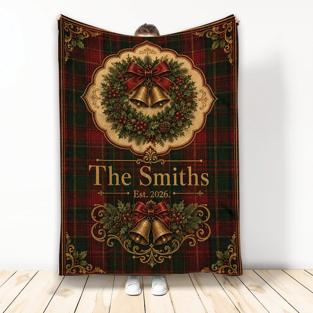 Christmas blanket with vintage tartan, holly wreath, red bow, golden bells, and festive greenery