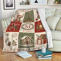 Christmas throw blanket draped over a sofa with rustic holiday panels, greenery, gifts, and a winter cabin