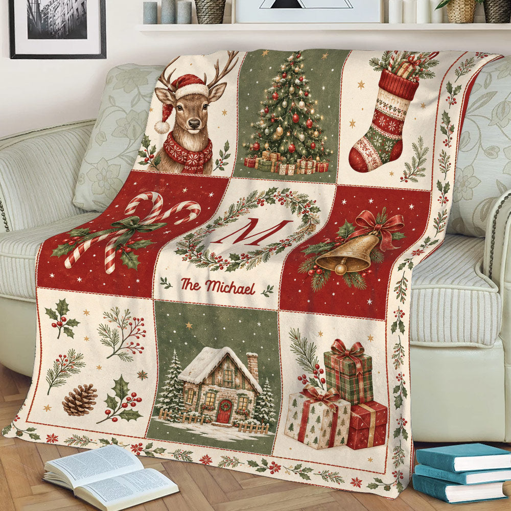 Rustic Christmas blanket shown on a sofa with reindeer, tree, stocking, bells, gifts, and winter cabin artwork
