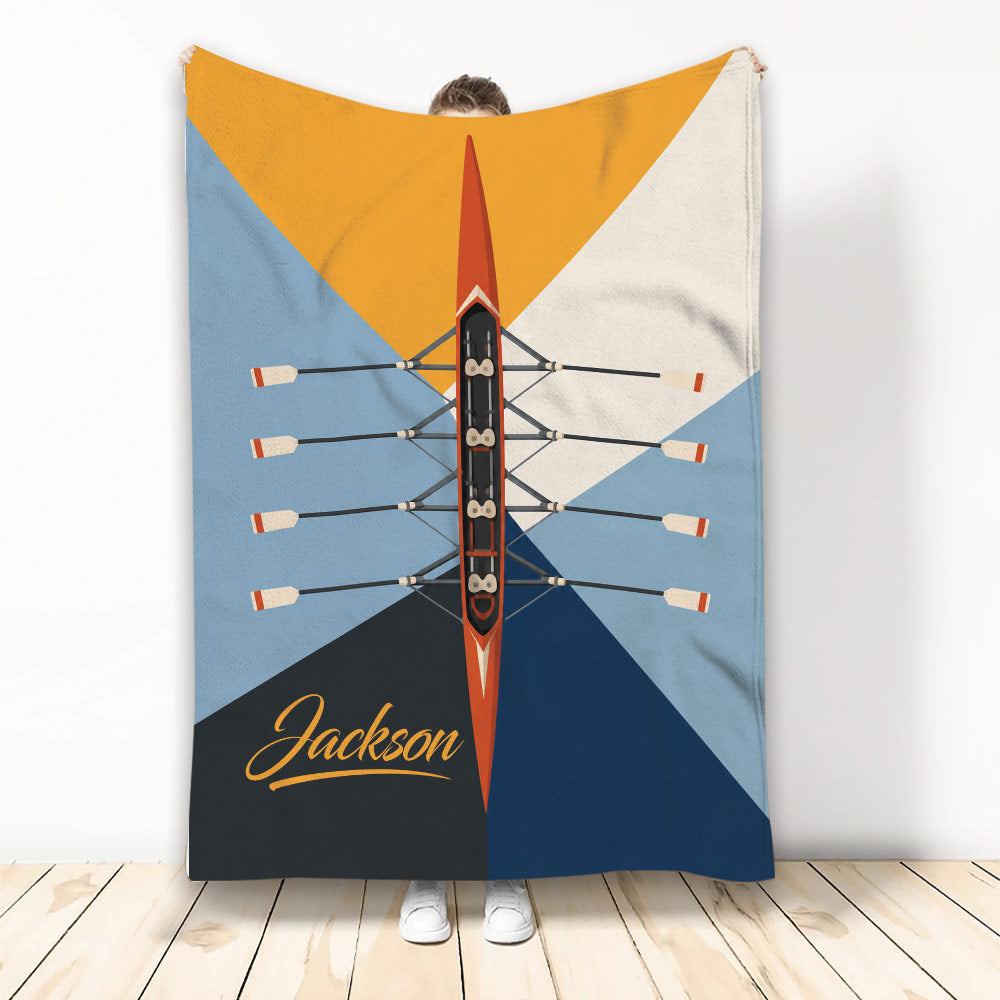 Rowing throw blanket with overhead racing shell, oars, and bold geometric blue, orange, and navy design