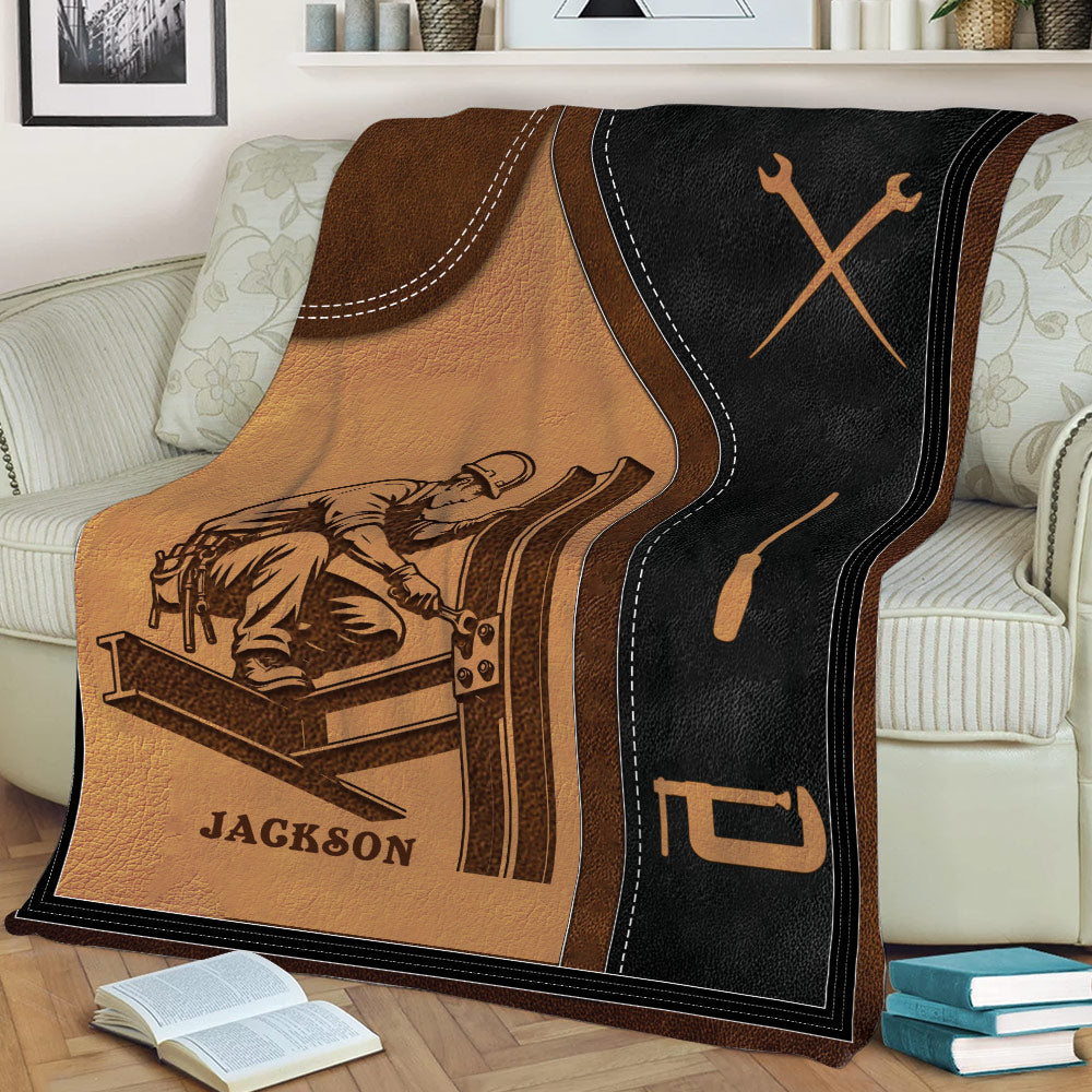 Close view of an ironworker throw blanket on a sofa with structural steel and hand tool illustrations