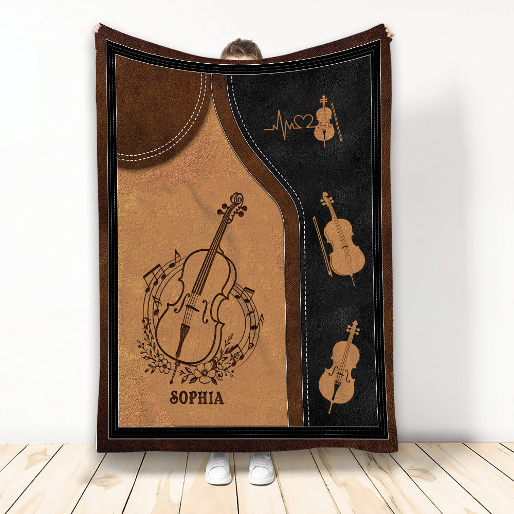 Cello throw blanket displayed upright with vintage brown and black instrument artwork and music note details