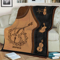 Close view of a cello blanket styled on a sofa with string instrument artwork and music-themed details