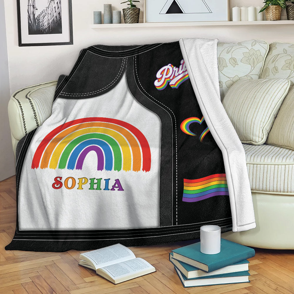 LGBT Pride blanket draped over a sofa with rainbow artwork and colorful Pride symbols
