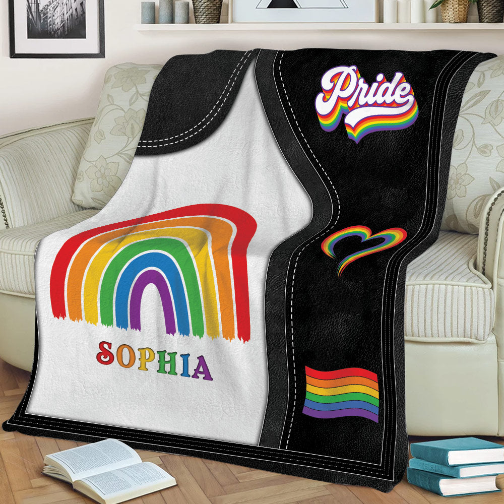 Close view of LGBT Pride throw blanket featuring a rainbow arch, heart, and Pride flag