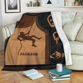 Rock climbing throw blanket draped over a sofa with climber, rope, carabiner, and mountain design