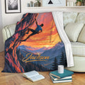 Rock climbing throw blanket draped over a couch with a sunset climber and mountain artwork