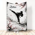 Taekwondo throw blanket with a dynamic martial artist silhouette, red blossoms, and ink wash artwork