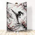 Taekwondo throw blanket with high-kicking martial artist and red blossom ink artwork