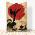 Taekwondo blanket featuring a kicking martial artist silhouette, red sun, Asian landscape, and temple artwork
