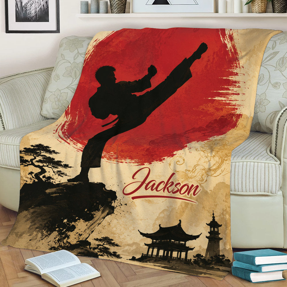 Martial arts throw blanket draped over a sofa with a kicking figure, red sun, trees, and temple landscape