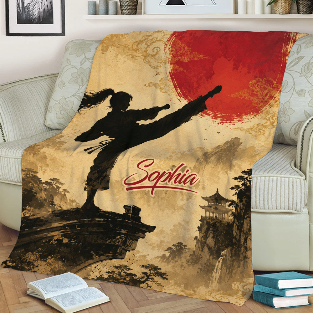 Taekwondo throw blanket displayed on a couch with martial artist silhouette, red sun, and mountain scenery