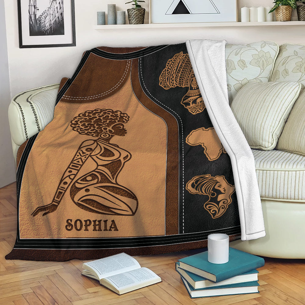 African woman throw blanket draped over a sofa with coordinated portrait and heritage artwork