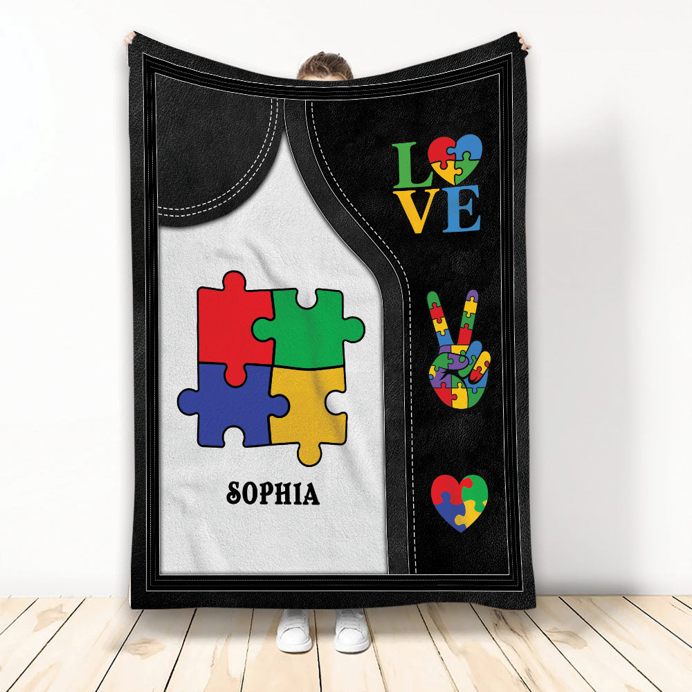 Autism throw blanket with colorful puzzle pieces, heart motifs, and black-and-white acceptance artwork