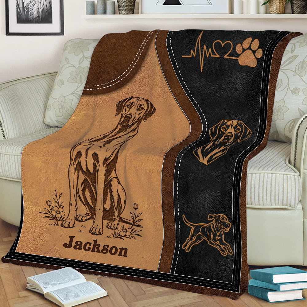 Rhodesian Ridgeback throw blanket draped over a couch with illustrated dogs and paw print artwork