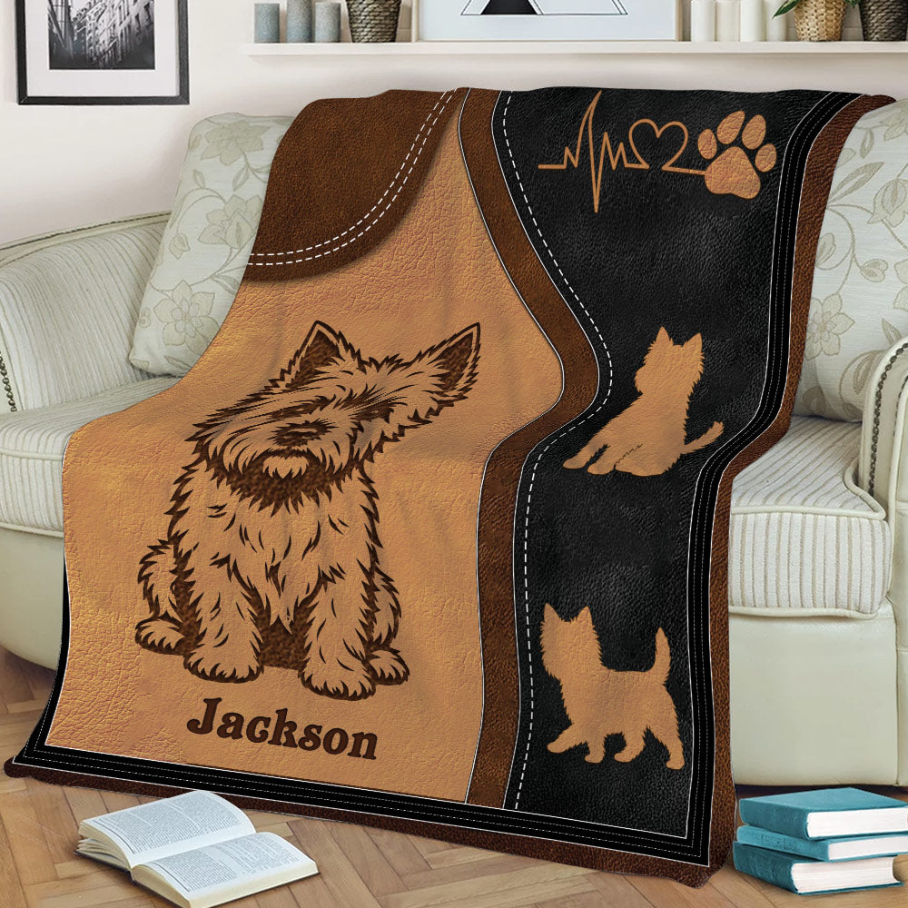 Close view of Cairn Terrier blanket design on a sofa with dog silhouettes and heart paw artwork