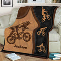 Close view of BMX blanket featuring a helmeted rider performing a bicycle trick