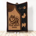 Pomeranian blanket with fluffy dog artwork, paw print accents, and warm brown and black design