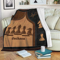 Chess throw blanket draped over a sofa, featuring classic chess pieces and warm brown and black artwork