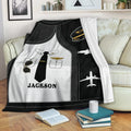 Pilot blanket displayed on a sofa with aviation uniform artwork, airplane silhouettes, and black and gold accents