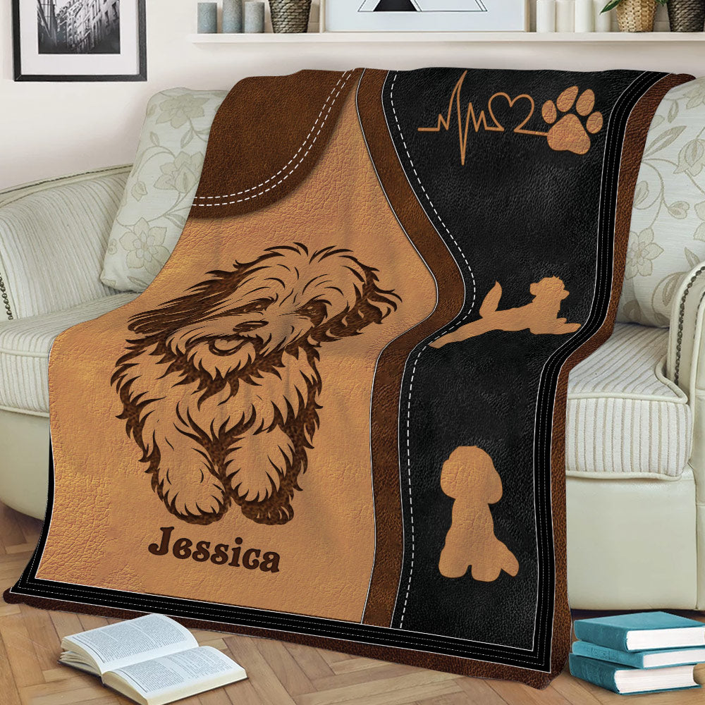 Close-up Havanese blanket featuring shaggy dog artwork, paw prints, heart detail, and leather-look styling