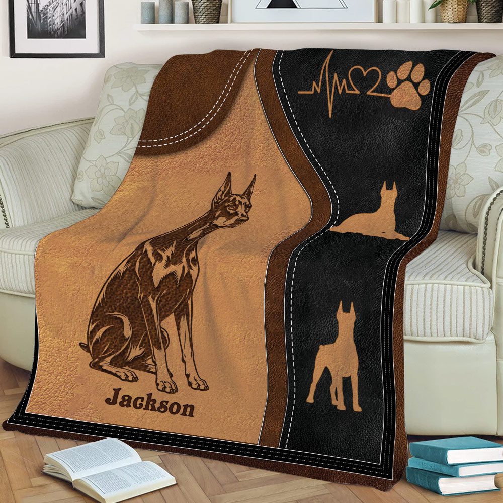 Close view of a Doberman blanket with detailed dog illustration, paw print, and heartbeat design