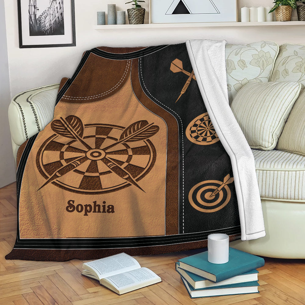 Rustic dart board throw blanket draped over a sofa with dartboard and darts design