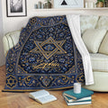 Blue and gold Hanukkah blanket with Star of David design draped over a living room sofa