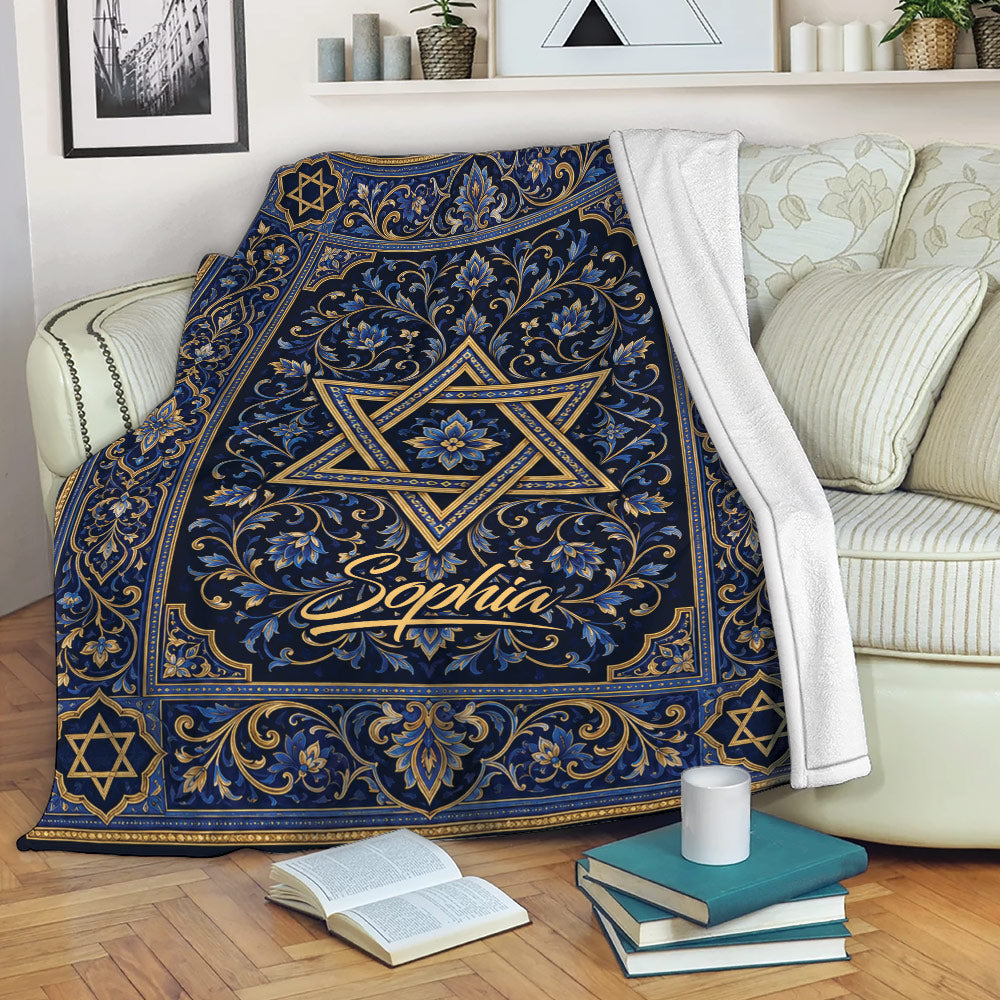Blue and gold Hanukkah blanket with Star of David design draped over a living room sofa