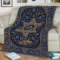 Ornate Hanukkah throw blanket with gold floral details and Star of David symbols on a couch