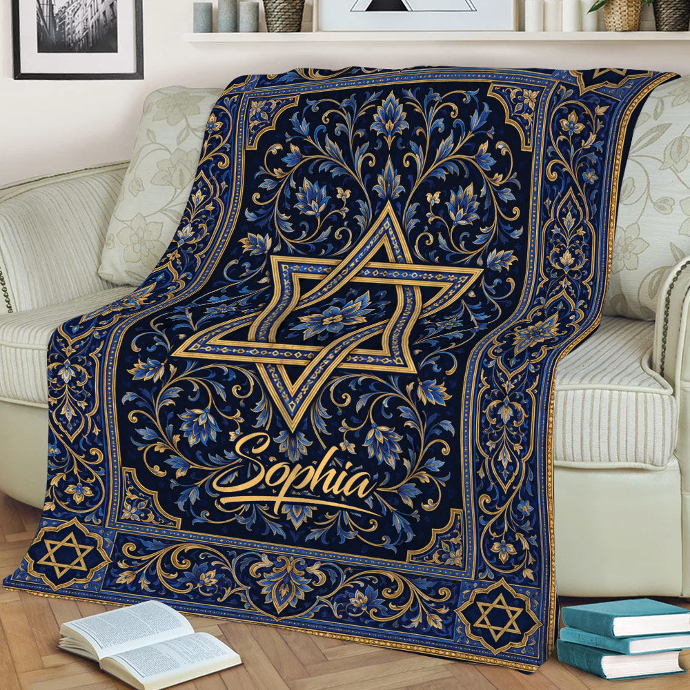 Ornate Hanukkah throw blanket with gold floral details and Star of David symbols on a couch