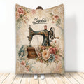 Vintage sewing machine blanket with floral fabric, lace details, thread spool, and elegant decorative artwork