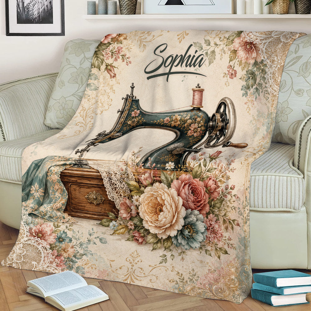 Close view of a floral sewing machine throw blanket styled on a sofa with vintage craft-inspired artwork