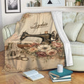 Vintage sewing throw blanket displayed on a sofa with floral sewing machine artwork and cozy reading decor